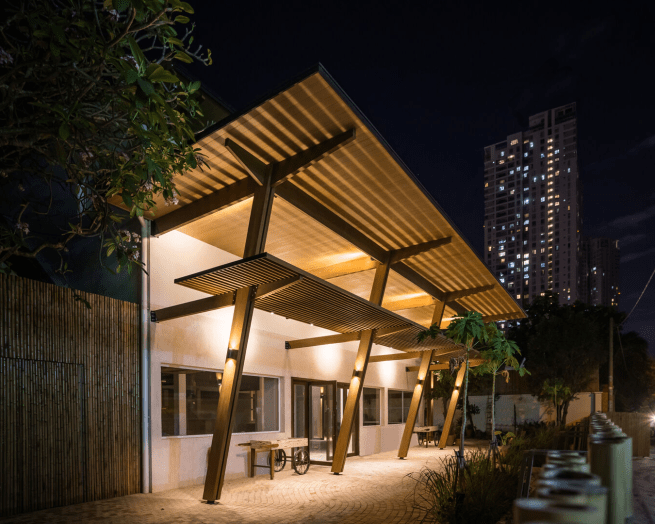 A home designed around existing trees, showcasing biophilic architecture.