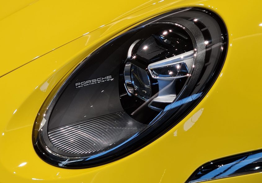 The interplay of light and reflections on a high-end car, showcasing modern automotive lighting design.