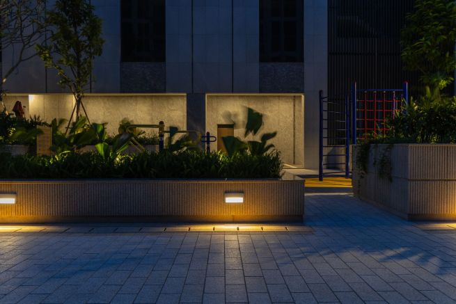 A softly illuminated walkway blending modern design with nature.