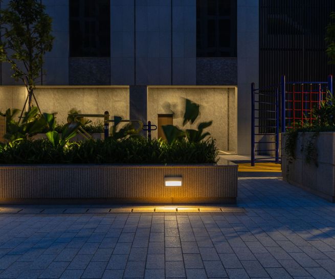 A softly illuminated walkway blending modern design with nature.